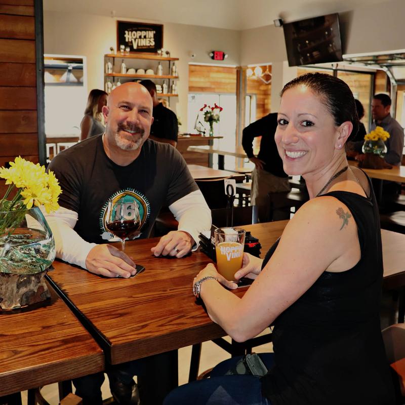 Customers smiling and enjoying drinks at the bar