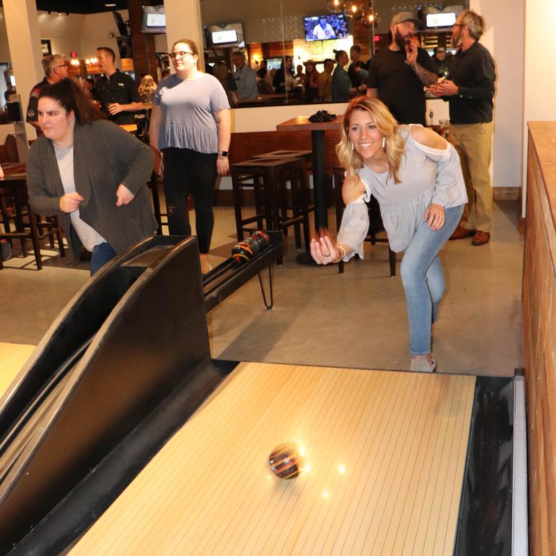 Patrons playing duckpin bowling